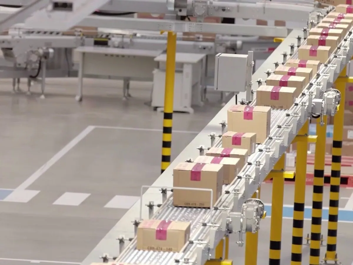 Conveyor system case study: vertical lift carrying cartons between levels in the Avon material flow.