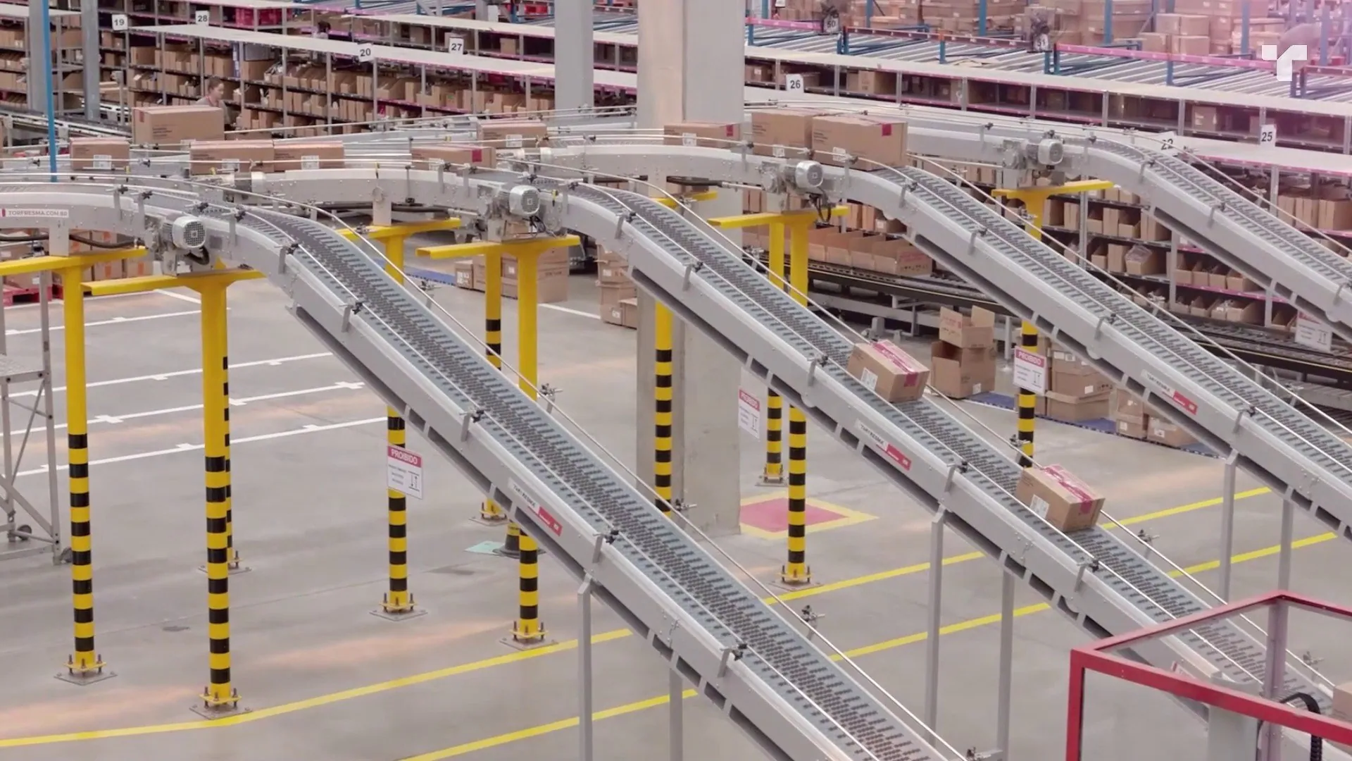 Personal care packaging automation: conveyor lines carrying cartons between levels of a distribution center.