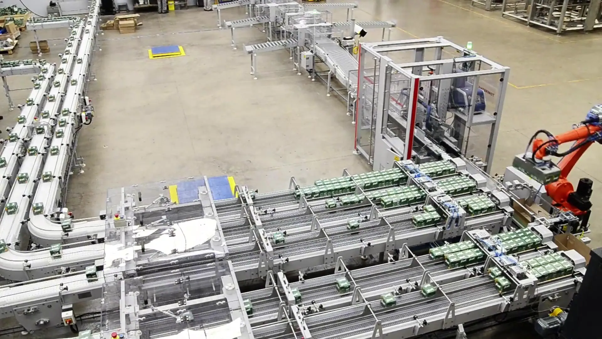 Conveyor lines connecting case packing to palletizing.