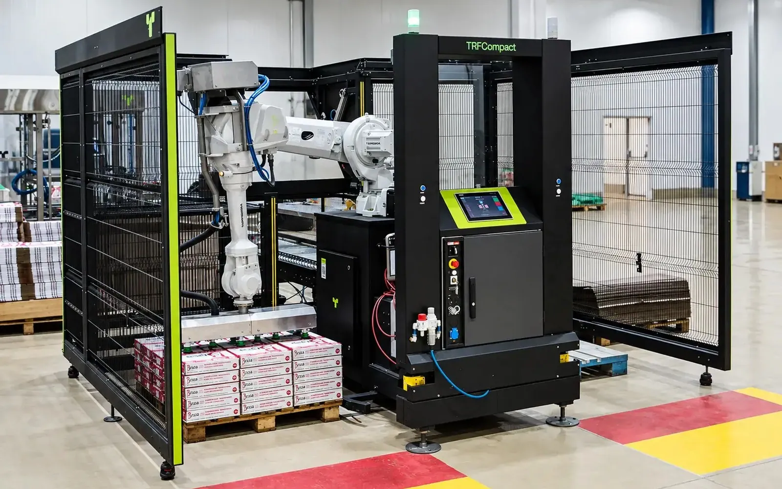 TRFCompact front view with the operator touch screen, safety fencing and a robot stacking cartons on a pallet.