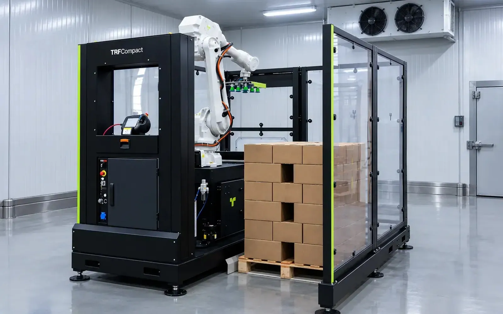 TRFCompact robot with a vacuum gripper stacking cases on a pallet inside its polycarbonate cell.